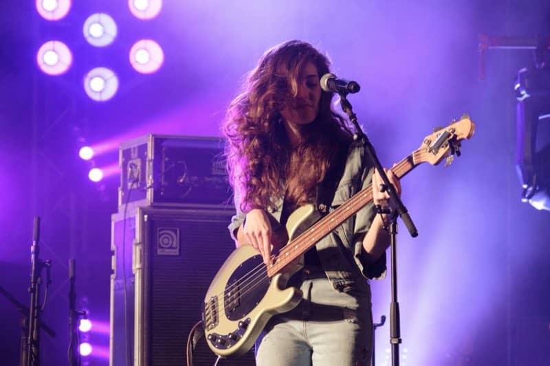 Bassist under a purple stage wash