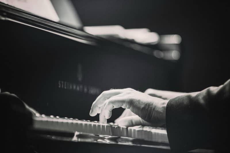 Hands on grand piano keys