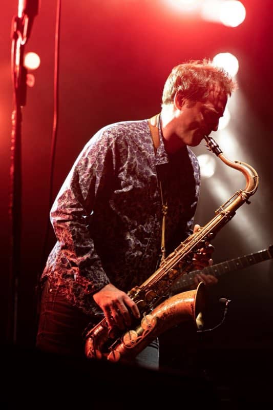 Saxophonist lit red on a club stage