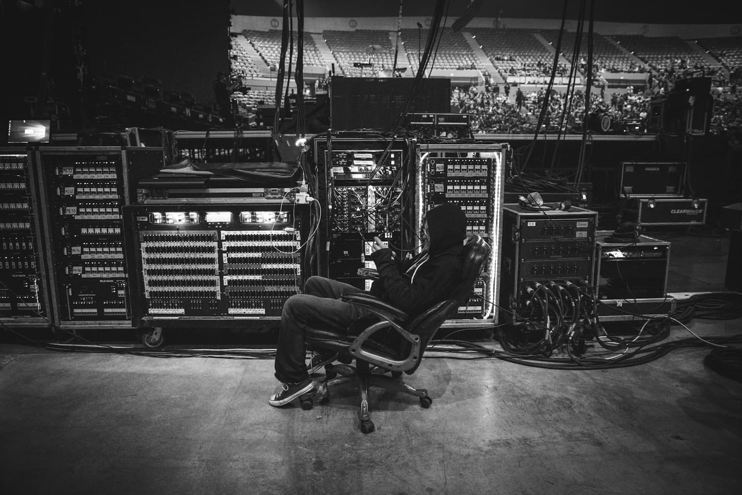 A live-sound engineer at the mixing rig before a show